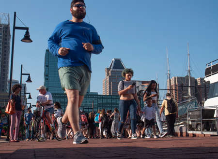 Baltimore, Maryland/USA - May 24, 2018: People Gather Along Baltimore Inner Harbor Waterfront Boardwalkのeditorial素材