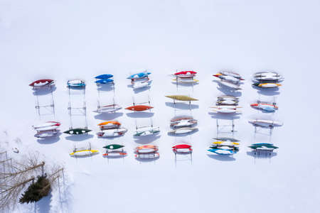 Kayaks Canoes Winter Storage Colorful Pattern Aerial Drone View Overhead Above Frozen Lakeの写真素材