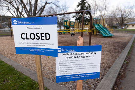 Bellingham, Washington USA - March 29, 2020: Playground Closed and Social Distancing Signs for...