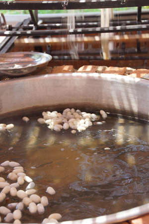 EPHESUS, TURKEY - MAY 25, 2014 - Boiling silkworm cocoons before unwinding silk, Ephesus, Turkey EPHESUS, TURKEY - MAY 25, 2014 - Boiling silkworm cocoons before unwinding silk, Ephesus, Turkey