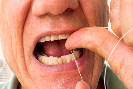 Wan Flossing his Bottom Front Teeth for Good Dental Hygieneの写真素材