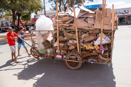 Planaltina, Goias, Brazil-July 27, 2019: A man collecting cardboard for recycling in a homemade cartのeditorial素材