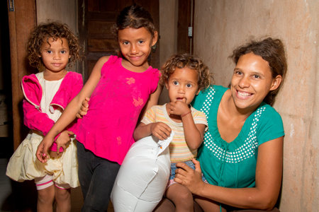Planaltina, GoiÃ¡s, Brazil-December 8, 2018: A poor Mother with three of her daughters inside their home in the impoverished community of Planatinaのeditorial素材
