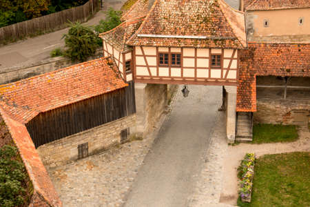 Rothenburg ob der tauber, Germany August 17, 2019: View of Part of the Stonewall and Towers that Surrounds the Medieval City of Rothenburg with Wind Turbines in the far backgroundのeditorial素材