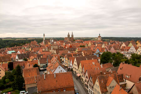 Rothenburg ob der tauber, Germany August 17, 2019: View of Part of the Stonewall and Towers that Surrounds the Medieval City of Rothenburg with Wind Turbines in the far backgroundのeditorial素材