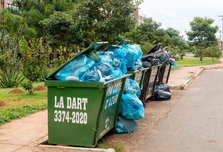 Brasilia, Brazil-February 10, 2020: Trash Pile up high and overflowing in a Neighborhood in the...