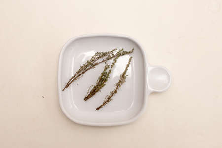 Fresh Thyme drying out on a white plateの写真素材