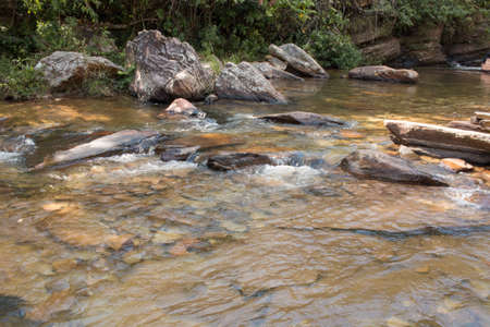 Water rushing down the small river at Waterfall Old Mill or Chachoeira da Usina Velha outside the...