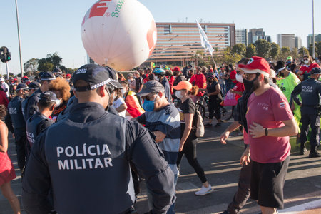 Brasilia, Brazil, DF July 25, 2021: Police keeping a watchful eye on the Demonstratorâs as they protest against the current administrationâs handling of the Covid-19 Vaccine.のeditorial素材