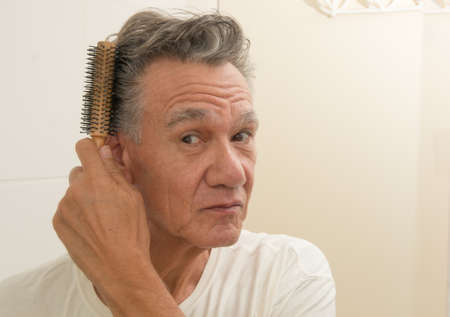Mature Man Brushing an Combing his Hair