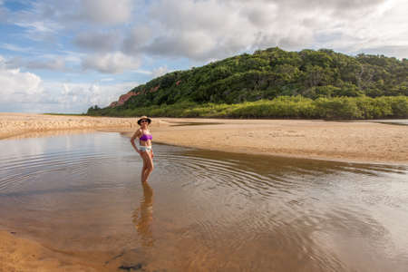 Lady standing at the beach known as Taipe near Arraial dâ Ajuda, Biaha, Brazilの写真素材