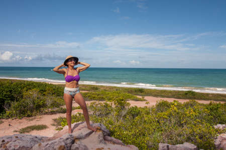 Lady at the beach known as Taipe near the colorful cliffs in Arraial d Ajuda Bahia, Brazilの写真素材