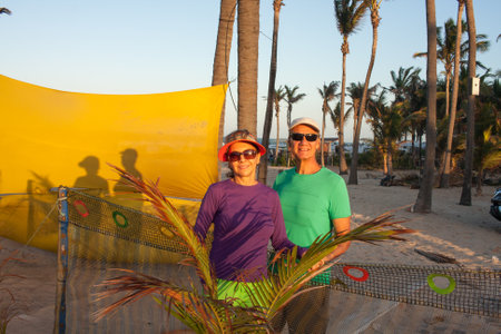 Couple standing against a yellow background in the late afternoonの写真素材