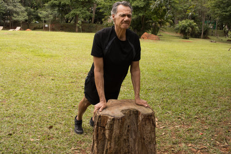 Mature Man outside at a local park doing Stretches before working outの写真素材