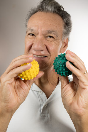 Mature man holding and squeezing massage therapy spike ballsの写真素材