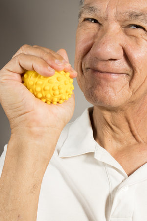Mature man holding and squeezing massage therapy spike ballsの写真素材