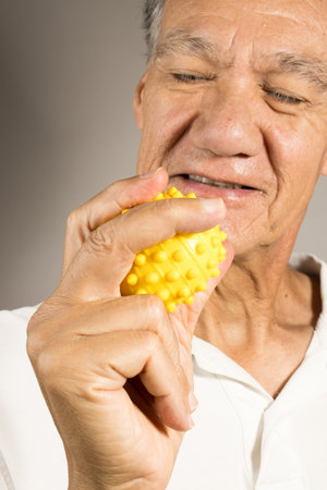 Mature man holding and squeezing massage therapy spike ballsの写真素材
