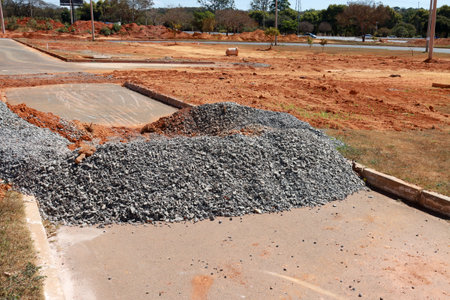 Dirt, rocks and gravel piled up on the street where sewer pipes are being laid in Northwest Brasilia, Brazilの写真素材