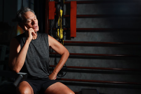 Portrait of an elderly man doing exercises in the gym. Health concept.の写真素材