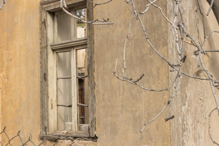 Old abandon home with broken window that can be found throughout the city in Athens, Greeceの写真素材