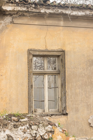 Old abandon home with broken window that can be found throughout the city in Athens, Greeceの写真素材