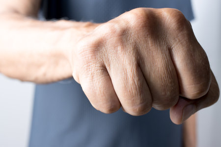 Close-up of a man's fist in a gesture of strengthの写真素材