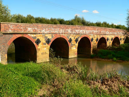 roman bridge built over a river in the countrisideの写真素材