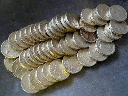lines of british pounds in a metal dish