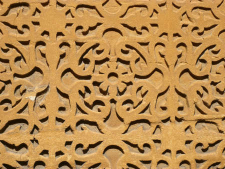 symmetrical stone carving on a wall in segovia in spainの写真素材
