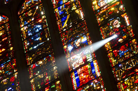 light shining through one of the stain glass windows in the cathedral of leon in spain