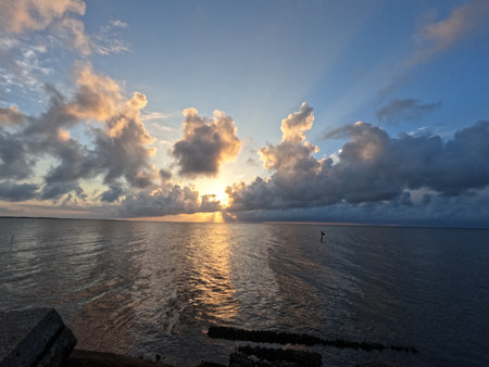 Morning Sunrise at the beach rocky and cloudy horizontalの写真素材