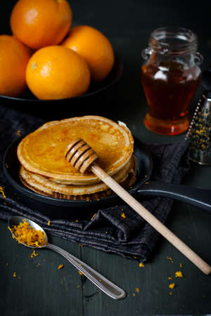 Pancakes with honey and orangesの写真素材