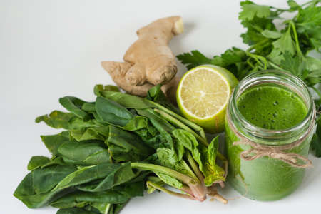 Detox green smoothie with ginger, speenach, lime, parsleyの写真素材