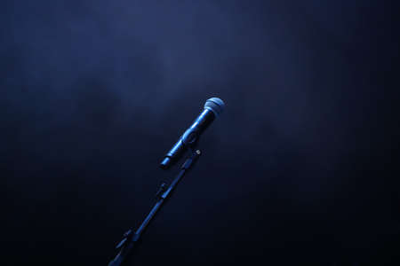 concert microphone on dark blue smoke background.の写真素材