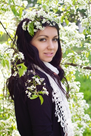Portrait of young brunette in the spring gardenの写真素材