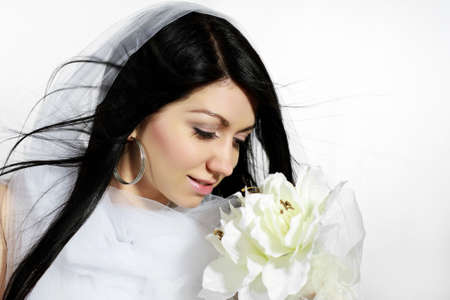 Beautiful  woman and white flowers near her face - white backgroundの写真素材