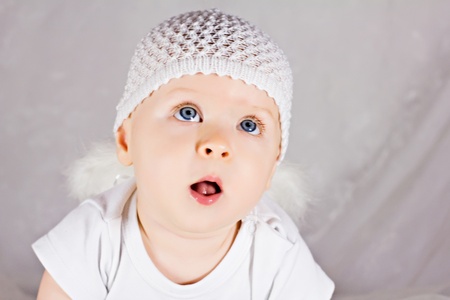 Sweet baby girl being impressed about something and looking upの写真素材