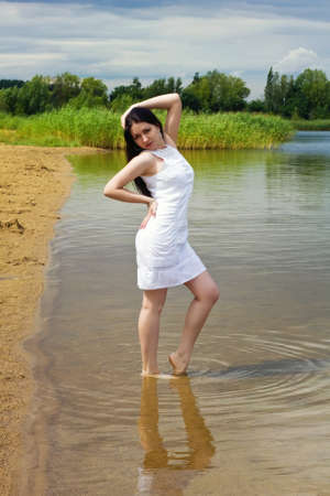 Young sexy girl at the lake shoreの写真素材