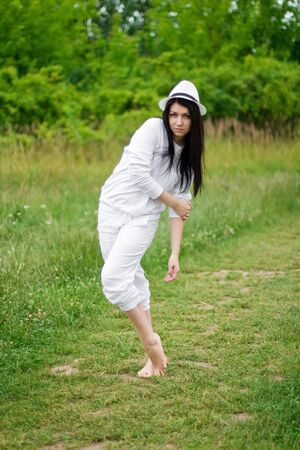 Beautiful young woman in white hat posingの写真素材