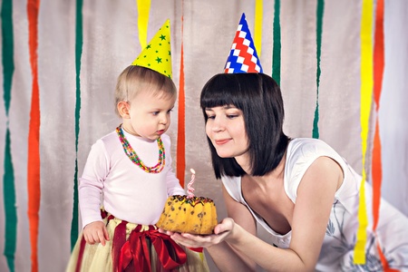 Portrait of mother with baby celebrating first birthdayの写真素材