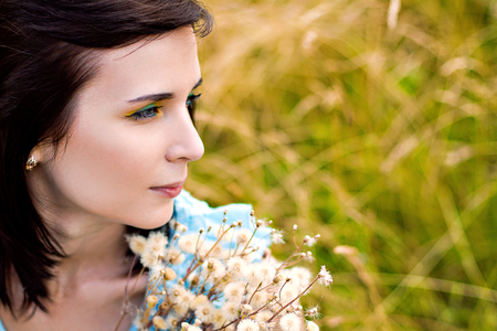 Summer portrait of young pretty girl on the meadowの写真素材