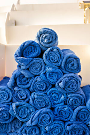 Stack of rolled blue towelsの写真素材
