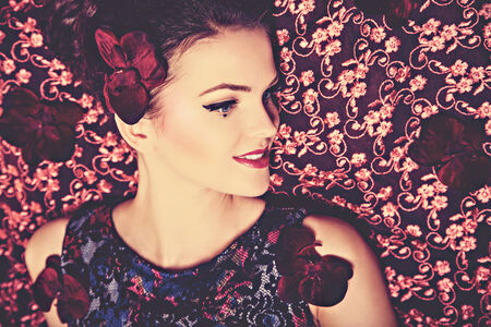 Portrait of the young beautiful woman with orchid flowers