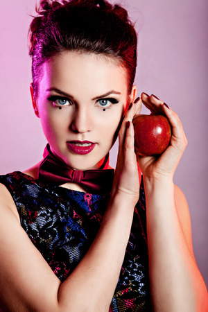 Beautiful young woman holding red appleの写真素材