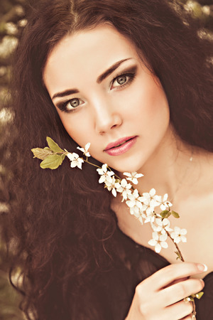 Spring - young woman under blossom treeの写真素材