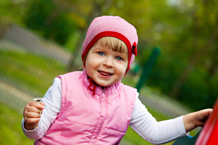 One little girl on playground near homeの写真素材