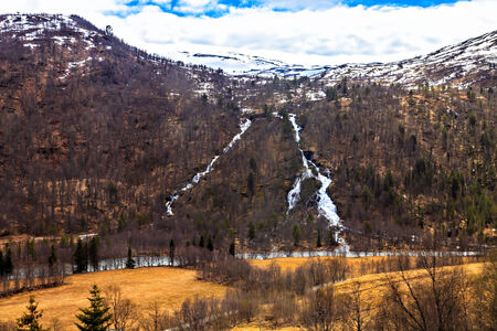 The norwegian landscape: river, forest and mountainの写真素材