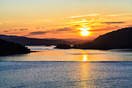Golden sun is reflected on the surface of the seaの写真素材
