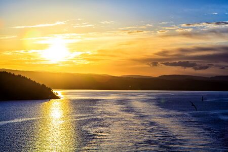 Golden sun is reflected on the surface of the seaの写真素材
