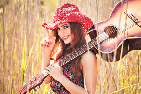 Romantic girl travelling with her guitar. Summer. Hippie style.の写真素材